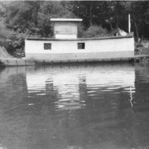 Houseboat with small towboat